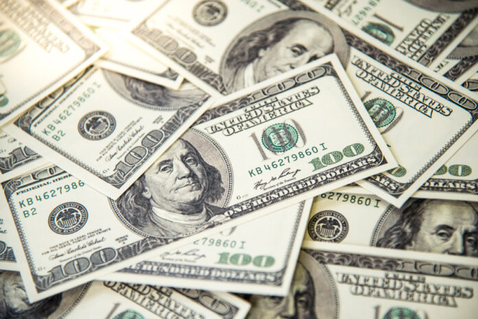 Pile of banknotes of one hundred dollars. Selective focus. Closeup. Background.